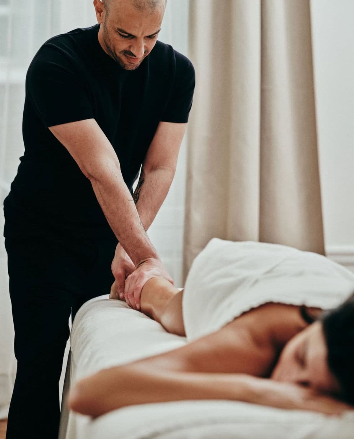A massage therapist treating a client