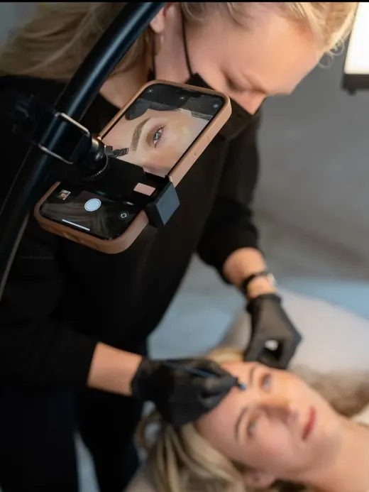 A trainer filming a treatment on a phone