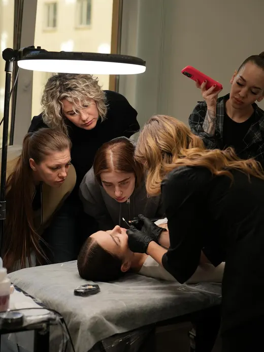 Students watching while the trainer works on a model