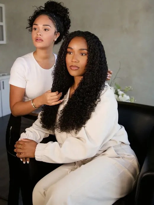 A hairdresser working on curly hair